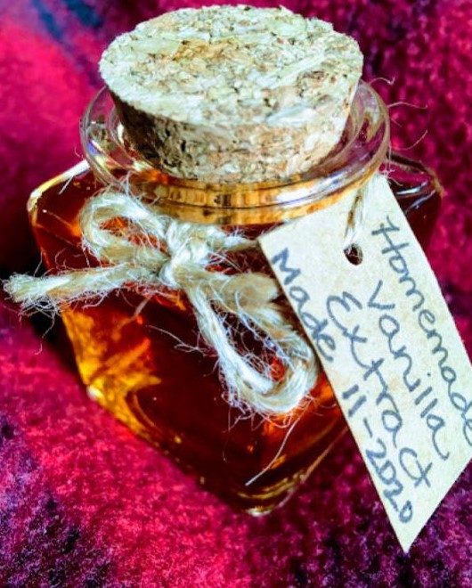 homemade vanilla extract sits on a plaid blanket