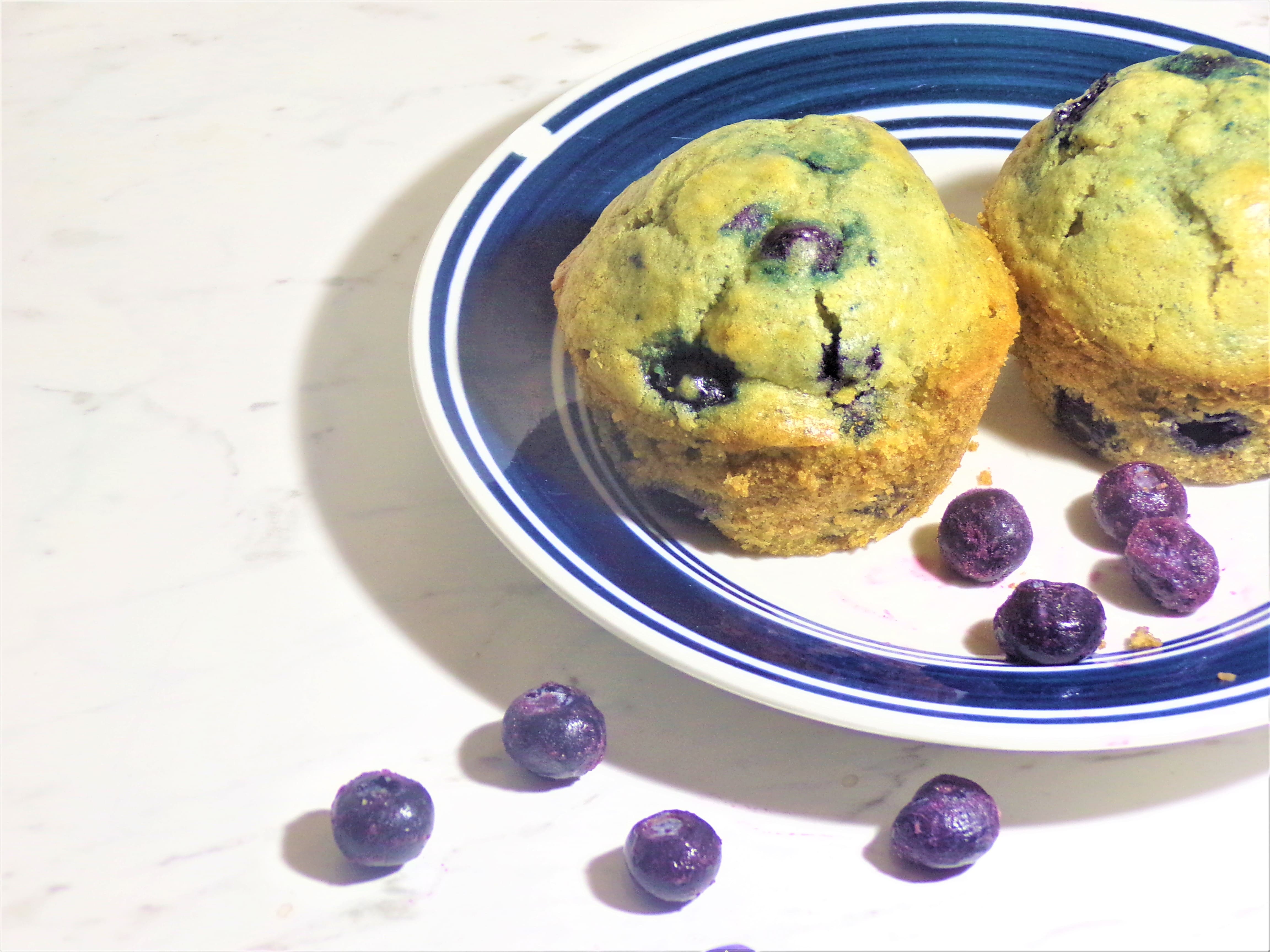 blueberry muffins with blueberries on a plate