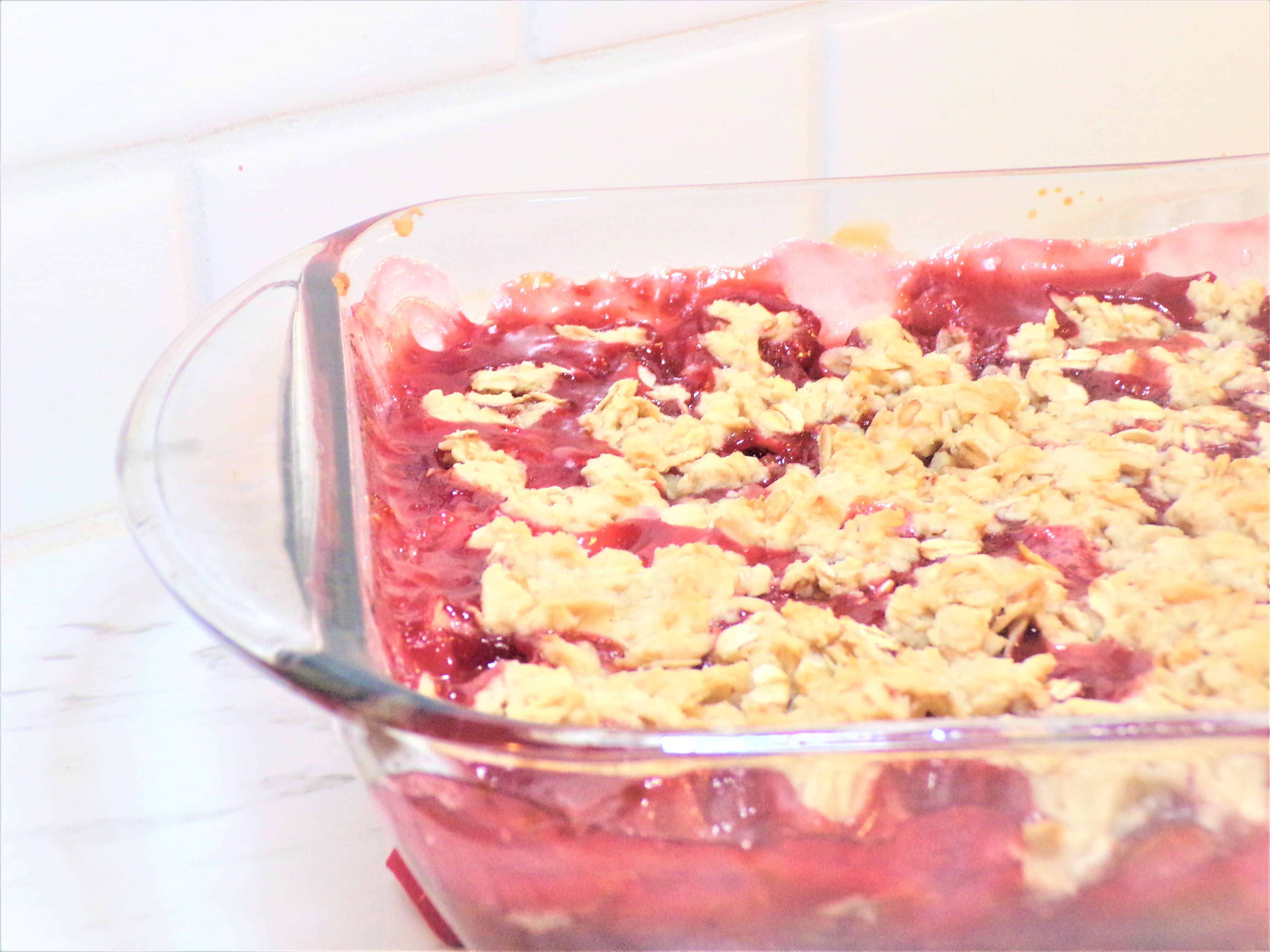 a pan of rhubarb raspberry cobbler on a counter