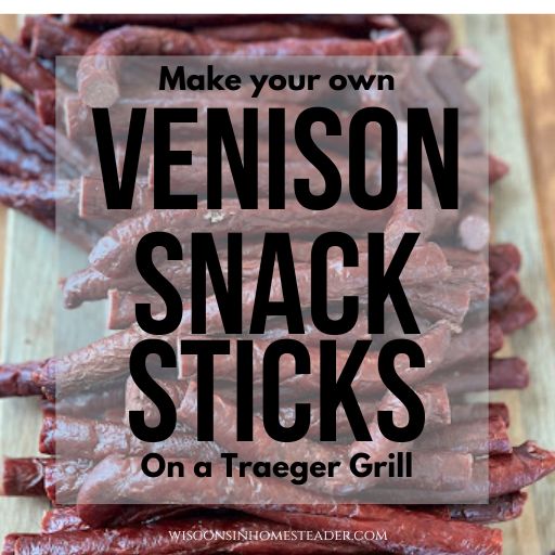 Venison snack sticks sit on a wooden cutting board