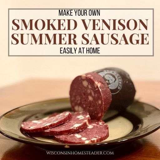Smoked venison summer sausage sits on a plate on a table